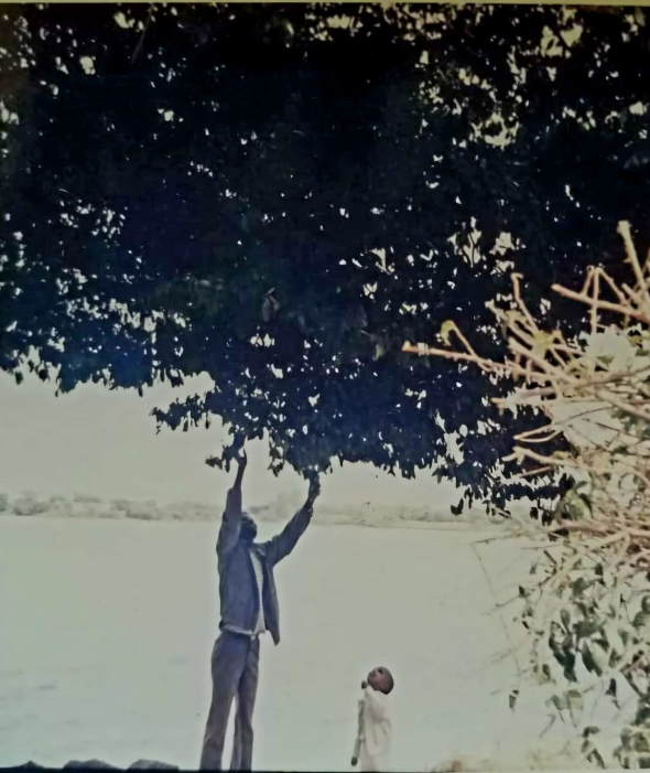 Professor Meareg Amare with one of his sons at Lake Tana, 1990s.
